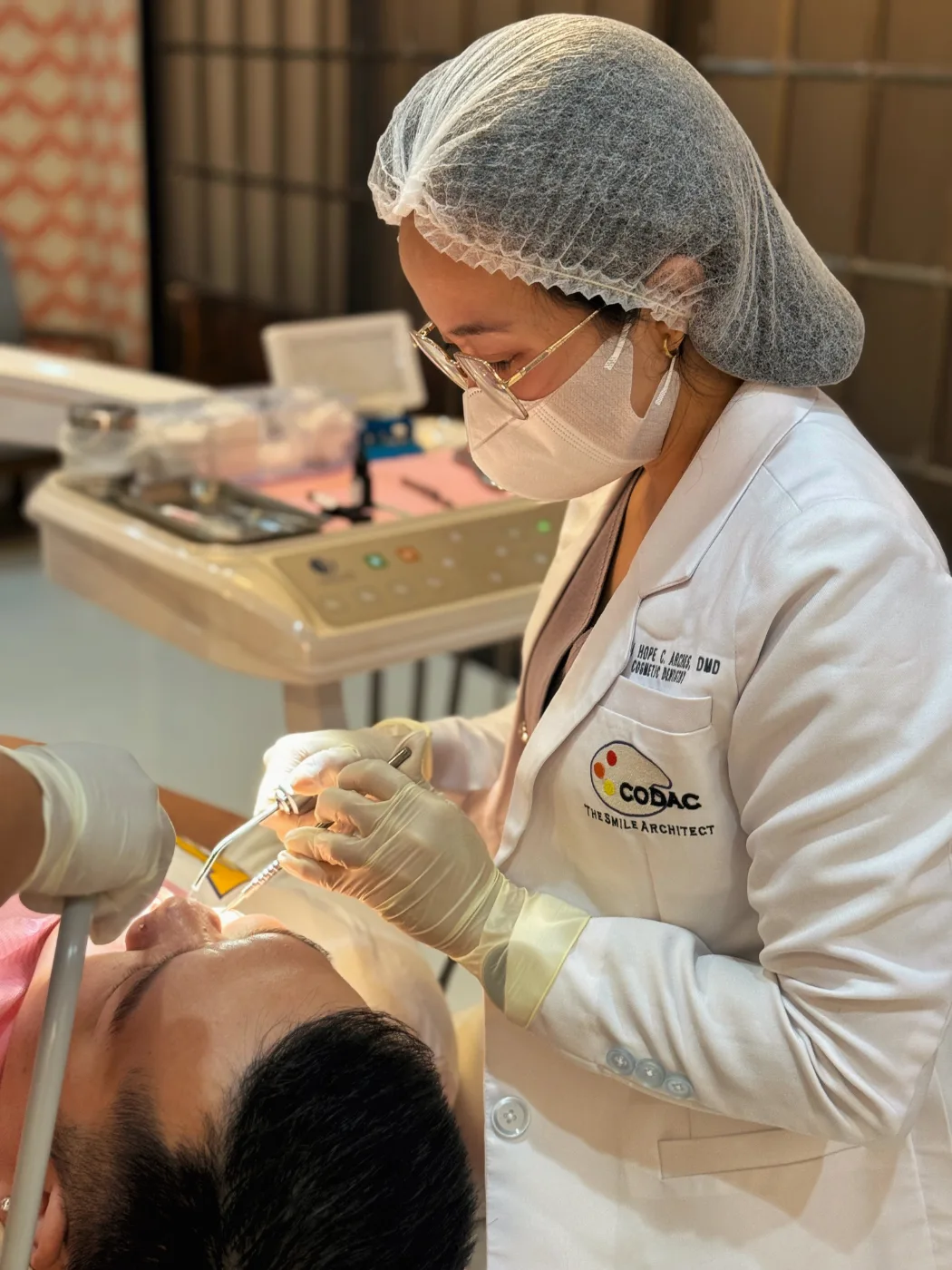 Dentist at Arches Dental Clinic consulting with a patient